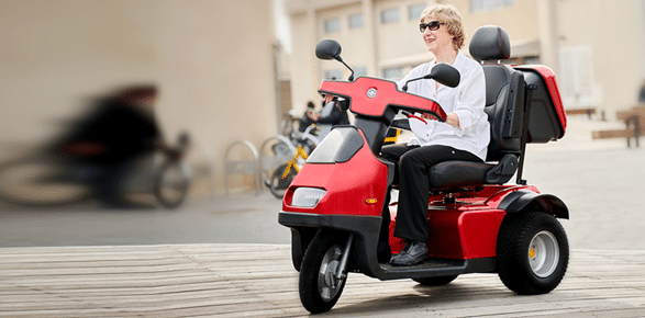 a woman on a 3 wheel red Afiscooter
